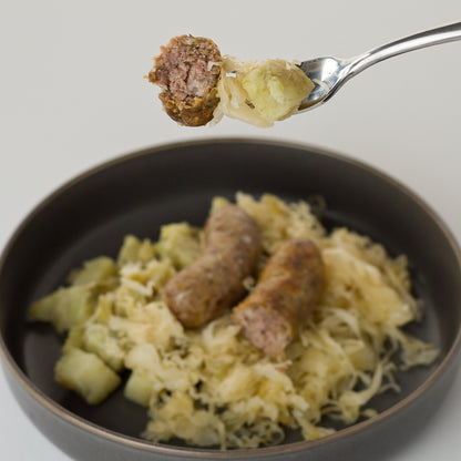 paleo brats sauerkraut potatoes on fork